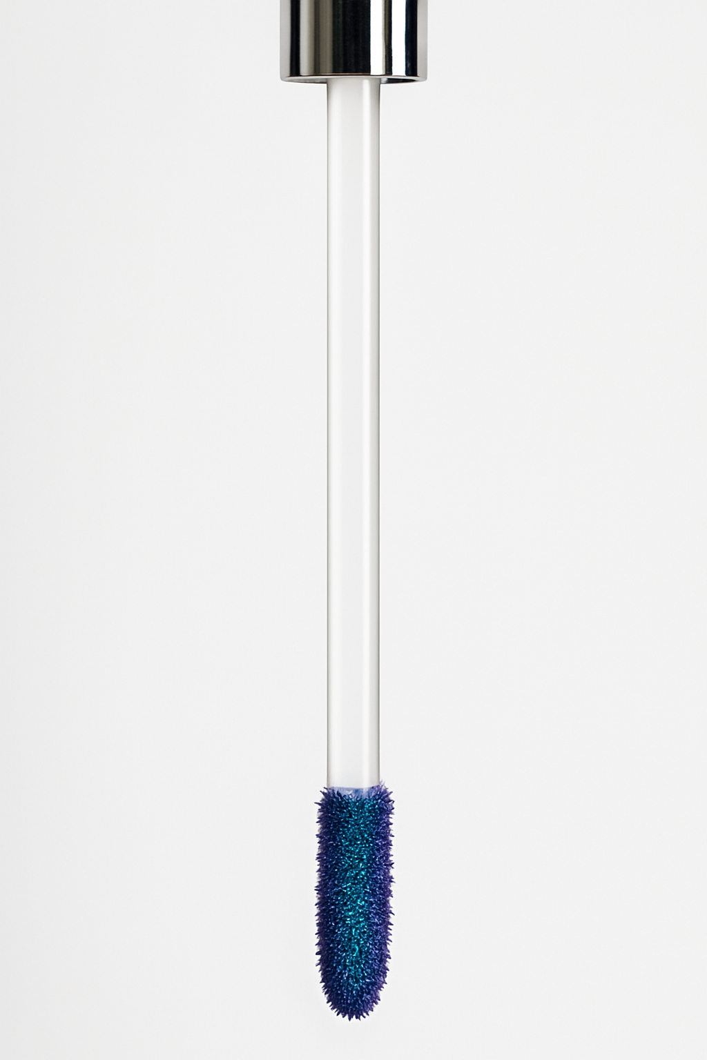 Close-up of doe-foot applicator coated in blue peel-off lip stain — Ocean Avenue Beauty.